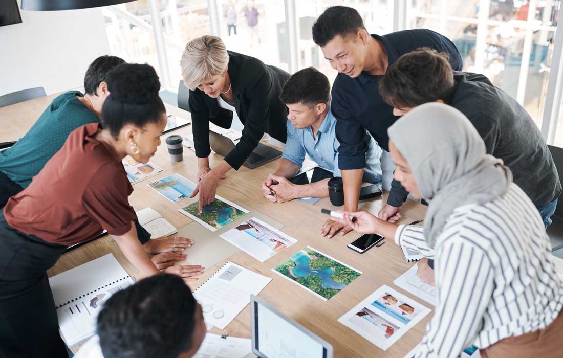 Shot of a group of businesspeople discussing paperwork during a